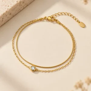 Alira double chain gold bracelet with single clear stone for women