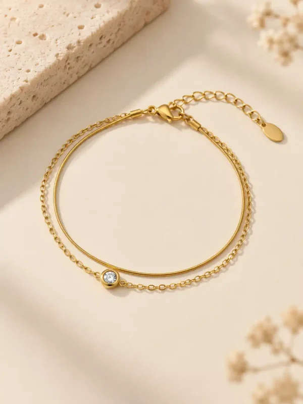 Alira double chain gold bracelet with single clear stone for women