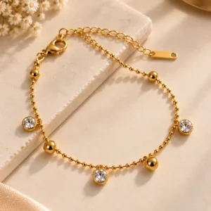 Aurelia gold beaded bracelet with three clear stone drop charms for women