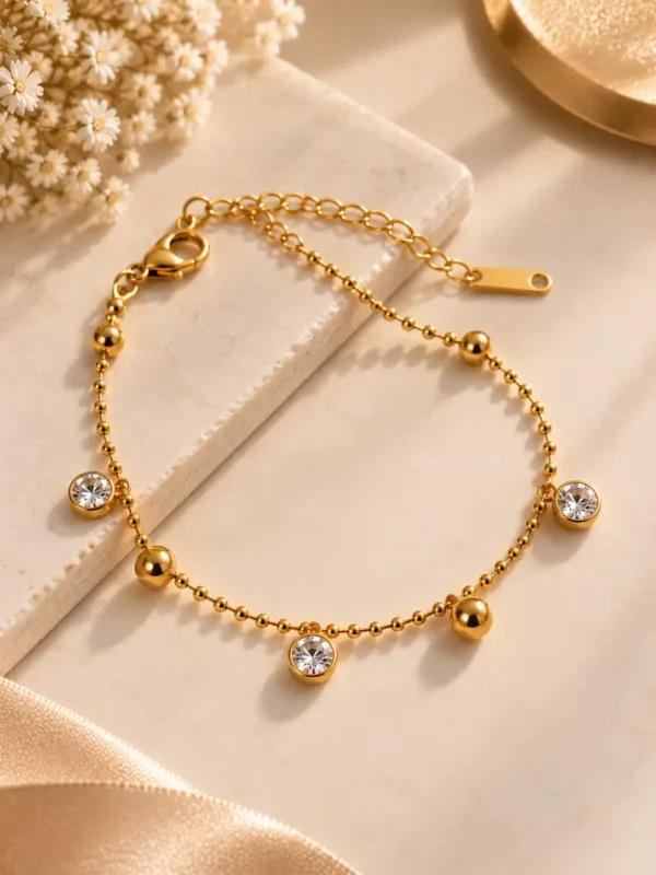 Aurelia gold beaded bracelet with three clear stone drop charms for women