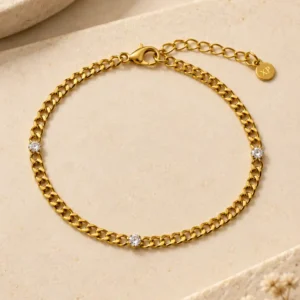 Avira gold curb chain bracelet with three clear stone accents for women