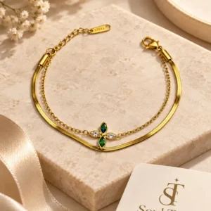 Elowen layered gold bracelet with green blue and clear floral stones
