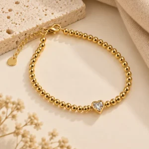 Elyra gold heart beaded bracelet with clear centre stone for women