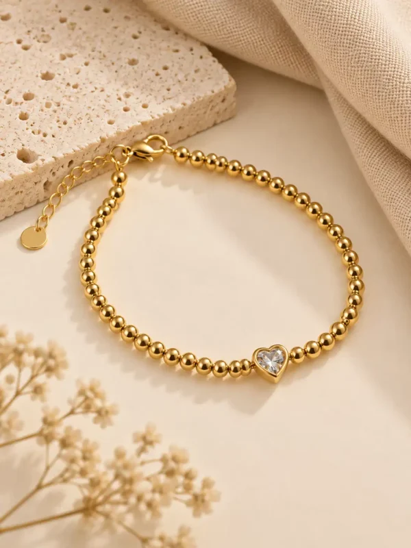 Elyra gold heart beaded bracelet with clear centre stone for women
