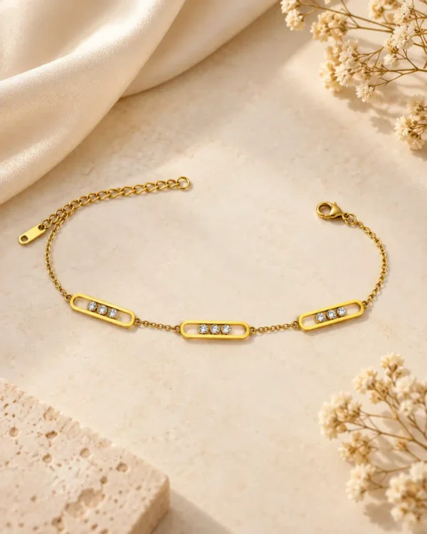 Evara geometric gold chain bracelet with three clear stone frame motifs