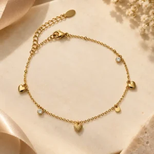 Valena gold heart charm bracelet with clear stone drops for women
