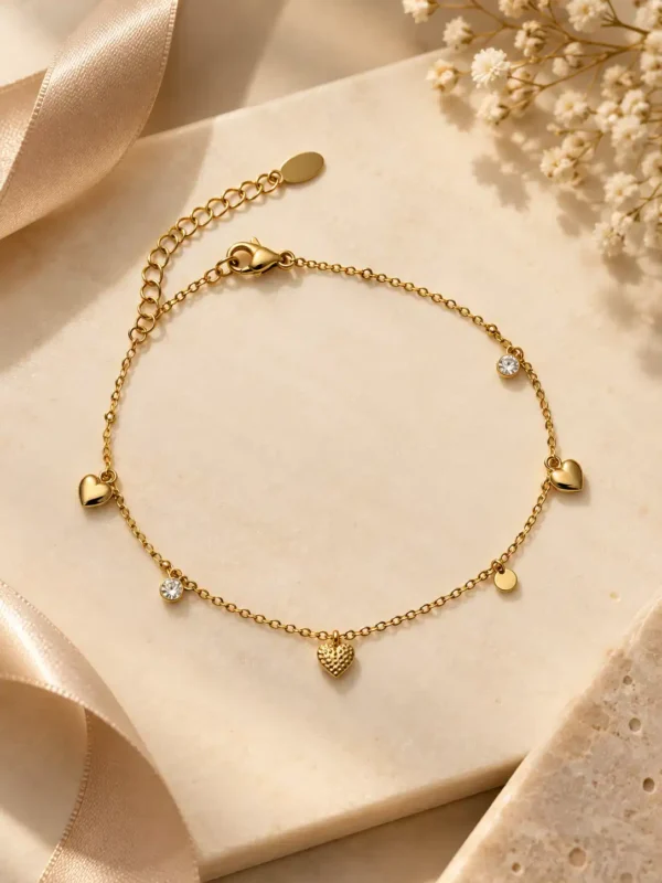 Valena gold heart charm bracelet with clear stone drops for women